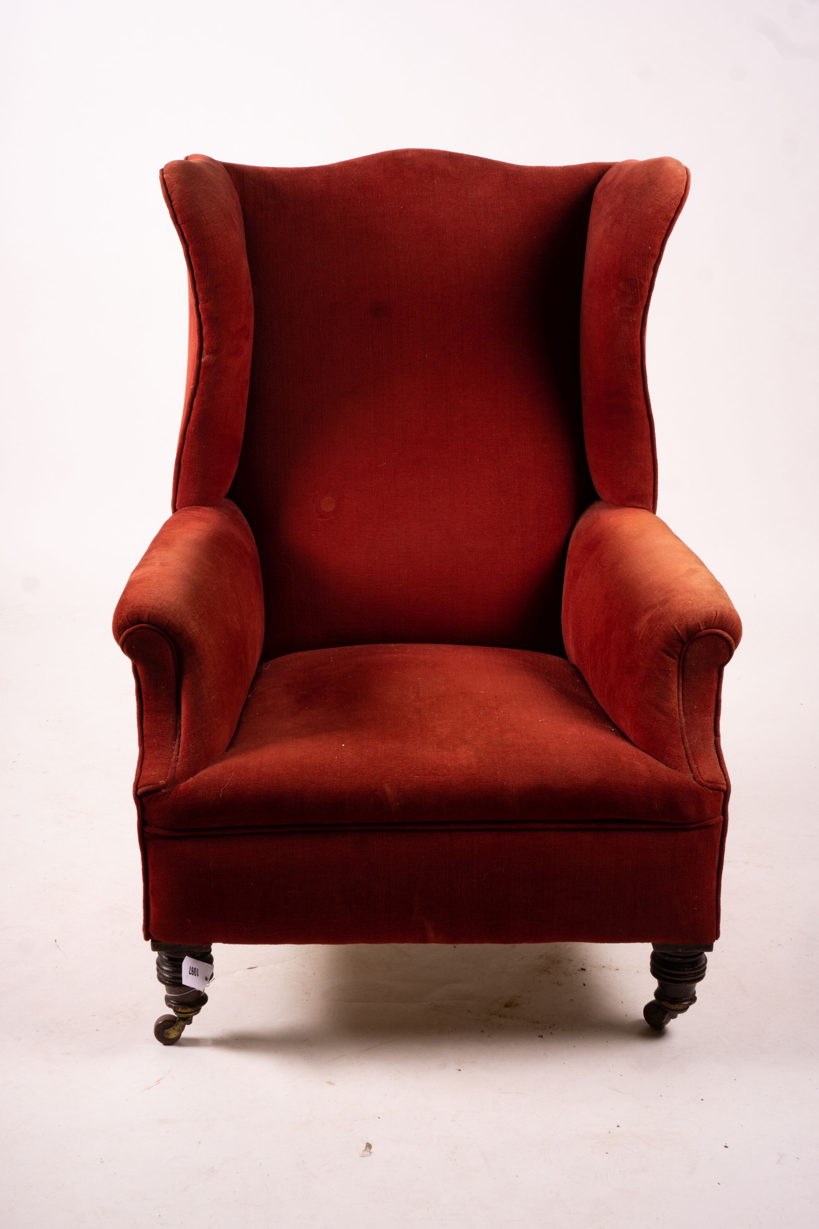 A late Victorian upholstered wing armchair, width 76cm, depth 70cm, height 100cm